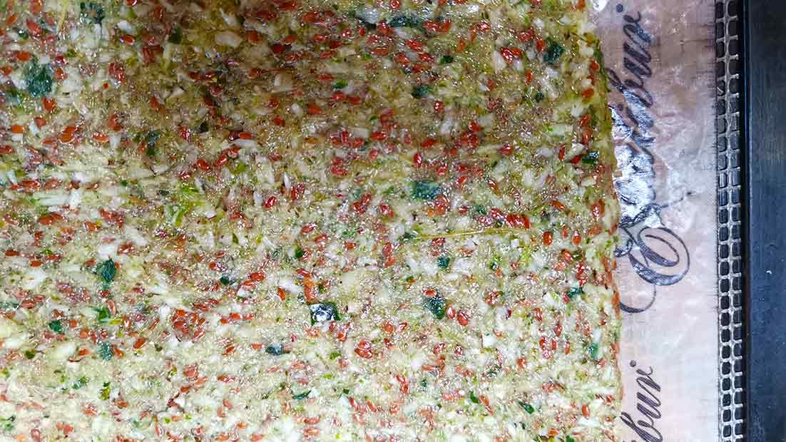 Raw cracker mixture in teflex sheets before dehydration.